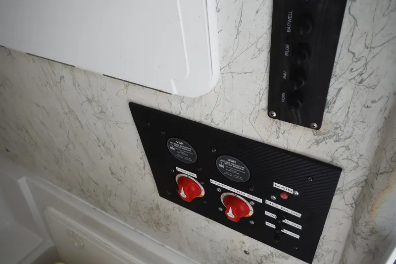 Slide: The Image of Control panel of a 2008 Sailfish 2660 CC boat with switches and dials. - 17