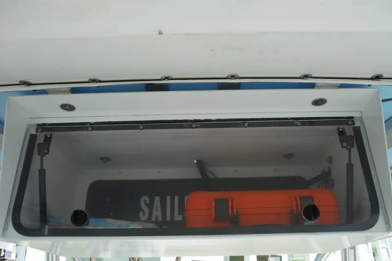 Slide: The Image of Storage compartment on a 2008 Sailfish 2660 CC boat with orange case inside. - 22