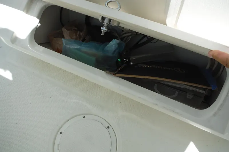 Slide: The Image of Storage compartment on a 2008 Sailfish 2660 CC boat, containing various items. - 23