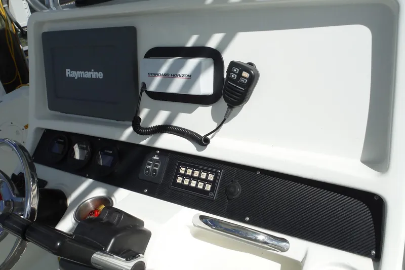 Slide: The Image of 2008 Sailfish 2660 CC boat dashboard with Raymarine and Standard Horizon equipment. - 25