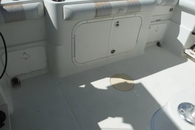 Slide: The Image of 2008 Sailfish 2660 CC boat interior with storage compartments and seating. - 26