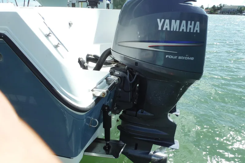 Slide: The Image of 2008 Sailfish 2660 CC boat with Yamaha four-stroke outboard motor on water. - 47