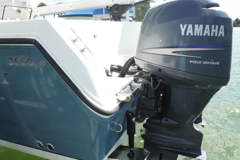 Slide: The Image of 2008 Sailfish 2660 CC boat with Yamaha four-stroke outboard motor on water. - 49