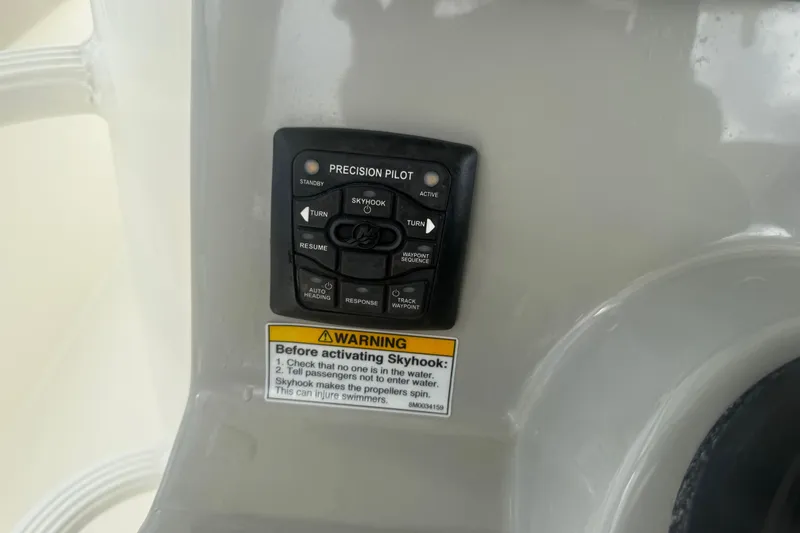 Slide: The Image of Control panel of 2016 Boston Whaler 330 Outrage with Skyhook feature warning. - 16