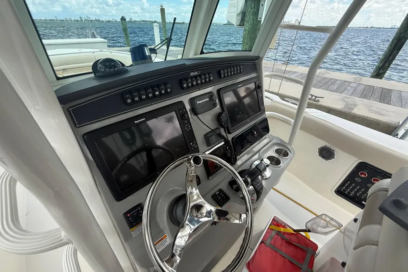 Slide: The Image of 2016 Boston Whaler 330 Outrage helm with advanced navigation systems and ocean view. - 17
