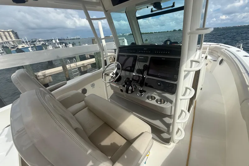 Slide: The Image of 2016 Boston Whaler 330 Outrage helm with dual screens, docked by the marina. - 18
