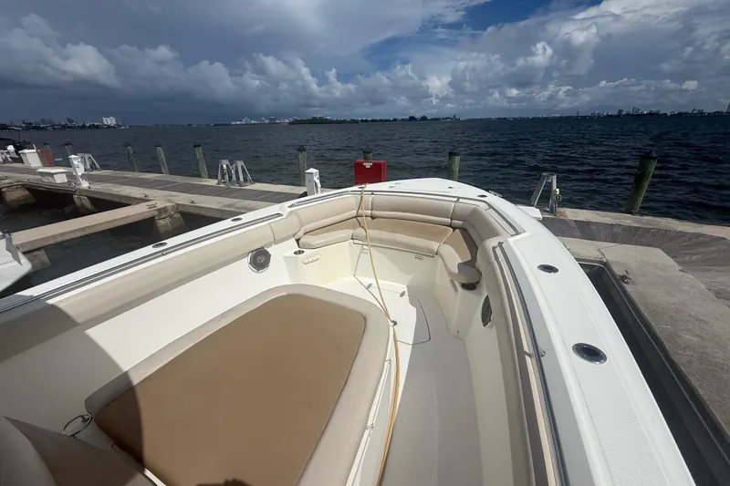 Slide: The Image of 2016 Boston Whaler 330 Outrage docked, showcasing spacious seating and ocean view. - 21