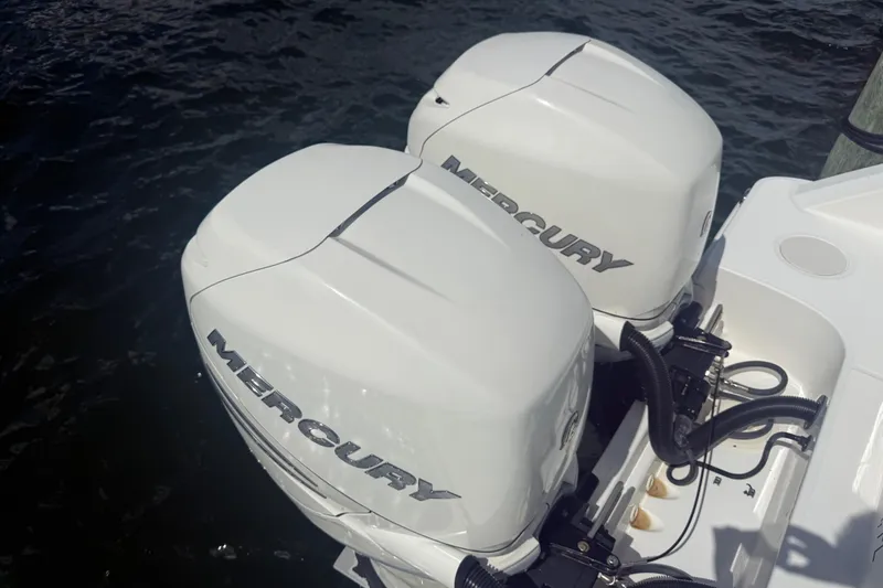 Slide: The Image of Twin Mercury outboard engines on a 2016 Boston Whaler 330 Outrage boat. - 25