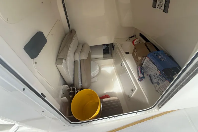 Slide: The Image of Interior cabin of 2016 Boston Whaler 330 Outrage with storage and seating. - 28