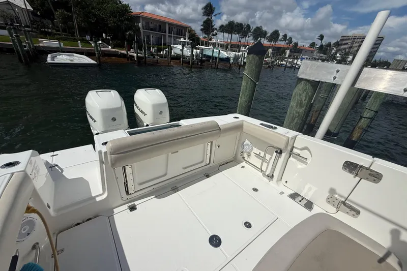 Slide: The Image of 2016 Boston Whaler 330 Outrage boat docked, featuring dual Mercury engines. - 8