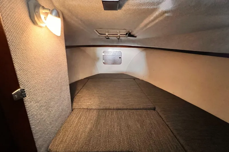 Slide: The Image of 1989 Shamrock 260 Hardtop cabin interior with cozy lighting and cushioned seating. - 20