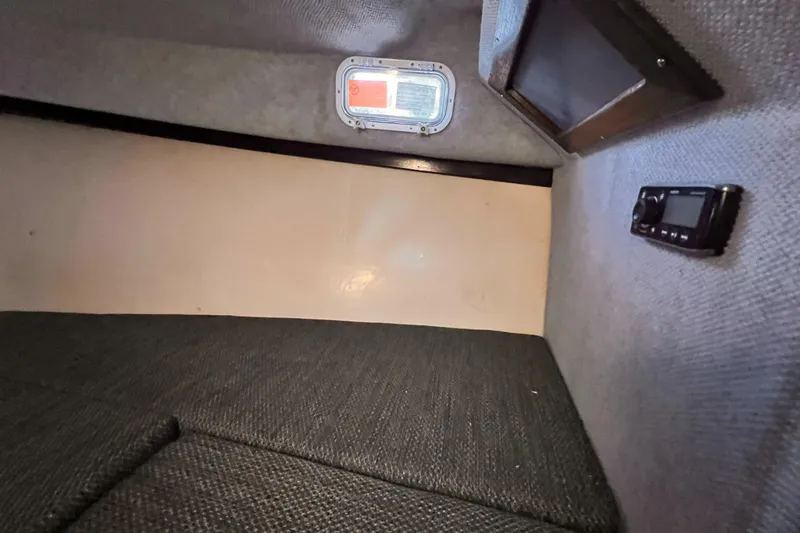 Slide: The Image of Interior cabin of 1989 Shamrock 260 Hardtop boat with window and radio. - 22