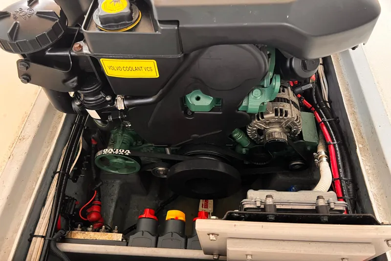 Slide: The Image of Engine compartment of a 1989 Shamrock 260 Hardtop boat, featuring Volvo components. - 30