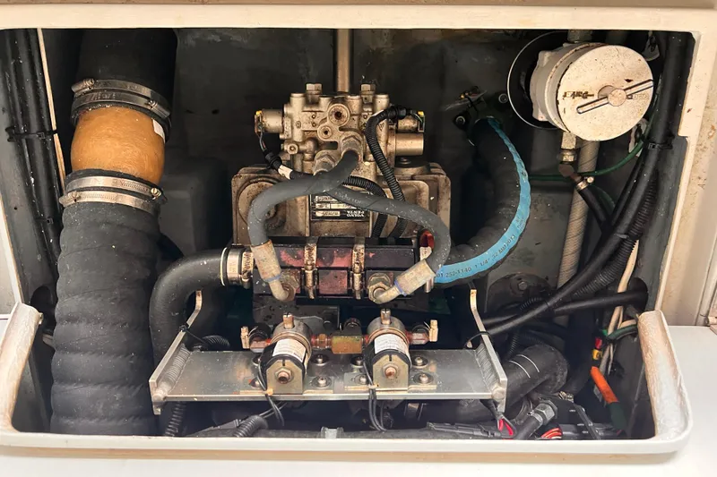 Slide: The Image of Engine compartment of a 1989 Shamrock 260 Hardtop boat, showing hoses and components. - 31