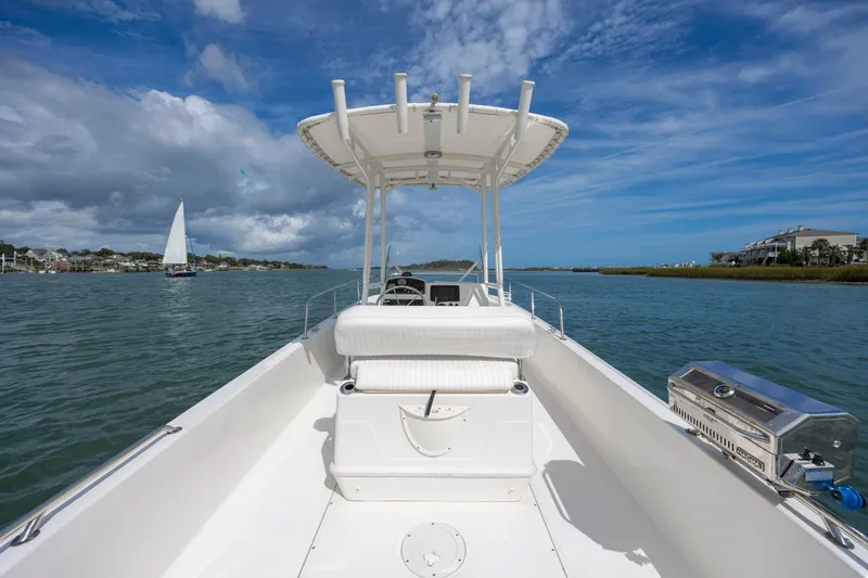 Slide: The Image of 2018 Boston Whaler 210 Montauk boat on calm water under blue sky. - 19