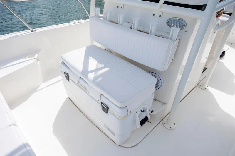 Slide: The Image of 2018 Boston Whaler 210 Montauk boat interior with cushioned seating and rod holders. - 23