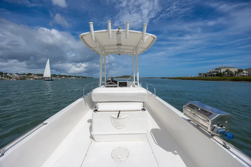 Slide: The Image of 2018 Boston Whaler 210 Montauk boat on calm water under blue sky. - 25