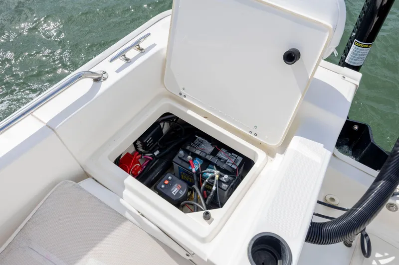 Slide: The Image of Open battery compartment on 2018 Boston Whaler 210 Montauk boat, showing marine battery and wiring. - 27