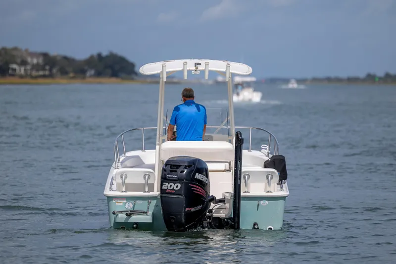 Slide: The Image of 2018 Boston Whaler 210 Montauk boat cruising on open water, rear view. - 5