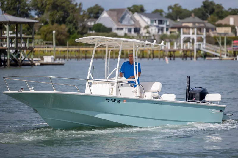 Slide: The Image of 2018 Boston Whaler 210 Montauk boat cruising on a scenic waterway. - 6