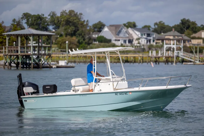 Slide: The Image of 2018 Boston Whaler 210 Montauk boat cruising on a scenic waterway. - 7