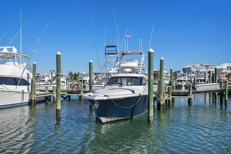 Slide: The Image of 2017 Jupiter 41SB boat docked at a marina on a sunny day. - 2