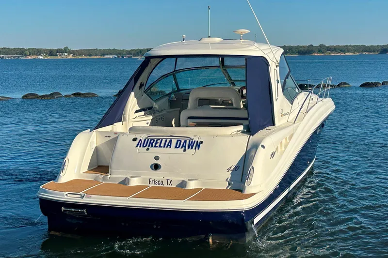 Slide: The Image of 2004 Sea Ray 420 Sundancer boat on water, rear view, named "Aurelia Dawn," Frisco, TX. - 12