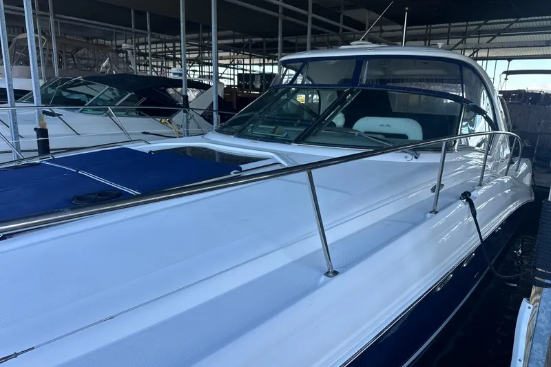 Slide: The Image of 2004 Sea Ray 420 Sundancer yacht docked in a marina, showcasing sleek design and luxury features. - 25