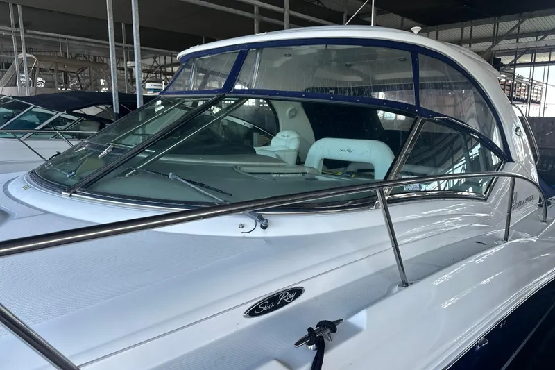 Slide: The Image of 2004 Sea Ray 420 Sundancer yacht in a marina, showcasing sleek design and spacious cockpit. - 26