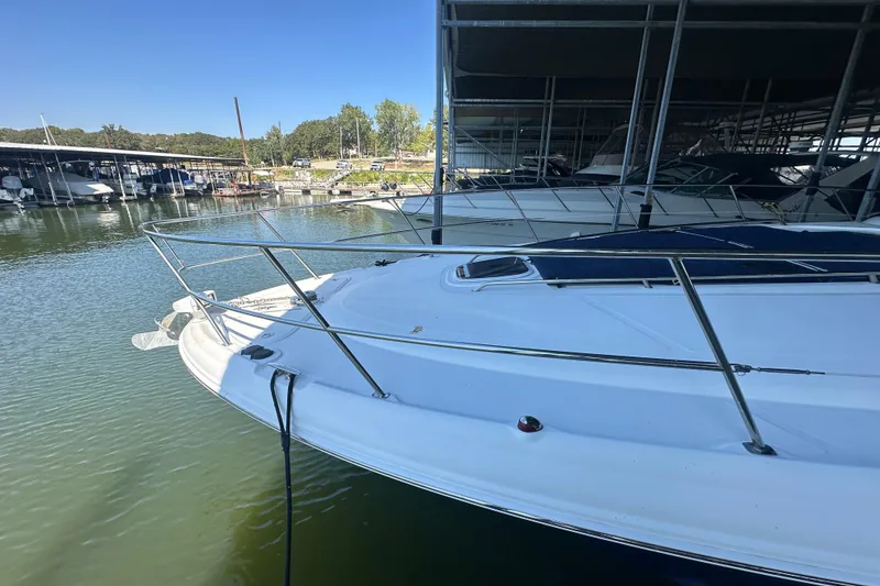 Slide: The Image of 2004 Sea Ray 420 Sundancer yacht docked in a marina under clear blue skies. - 28