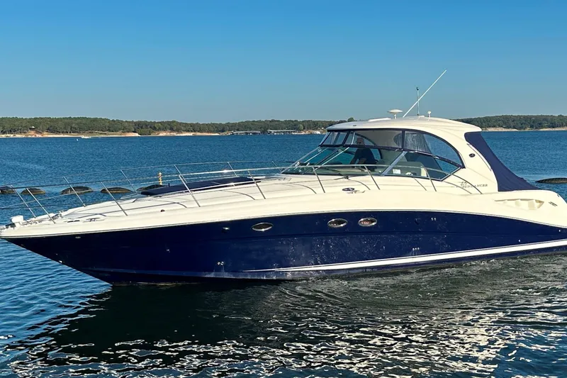 Slide: The Image of 2004 Sea Ray 420 Sundancer yacht cruising on a serene blue lake. - 3