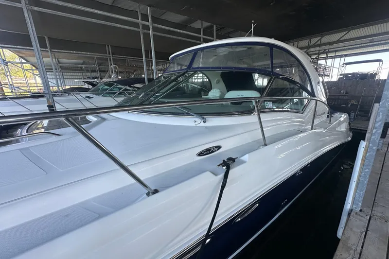 Slide: The Image of 2004 Sea Ray 420 Sundancer yacht docked in a covered marina. - 30