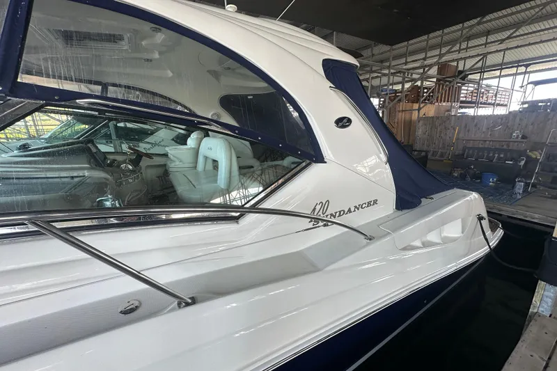 Slide: The Image of 2004 Sea Ray 420 Sundancer yacht docked in a marina, showcasing sleek design and luxury interior. - 31