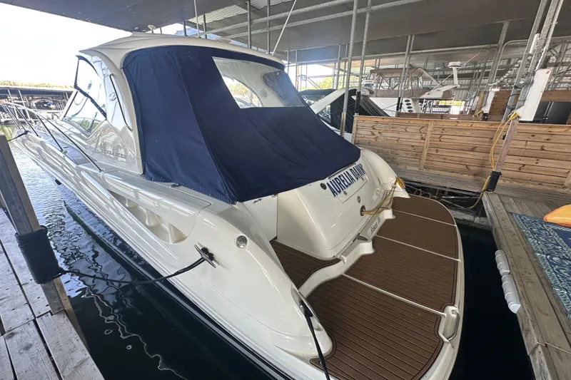 Slide: The Image of 2004 Sea Ray 420 Sundancer docked in a covered marina slip. - 32