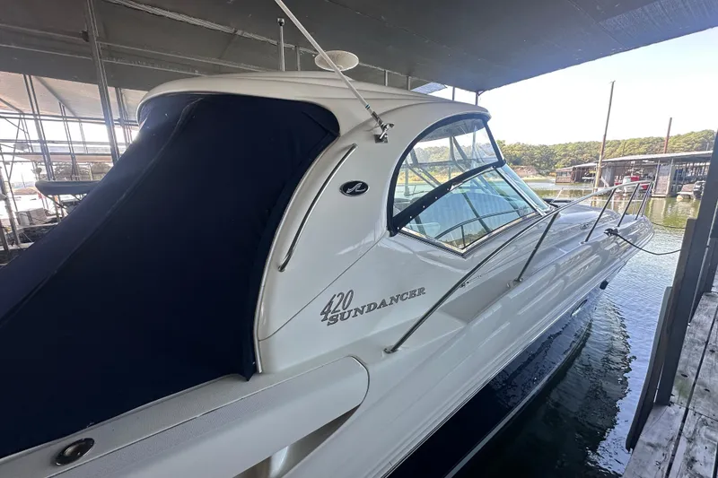 Slide: The Image of 2004 Sea Ray 420 Sundancer yacht docked under a covered marina. - 35