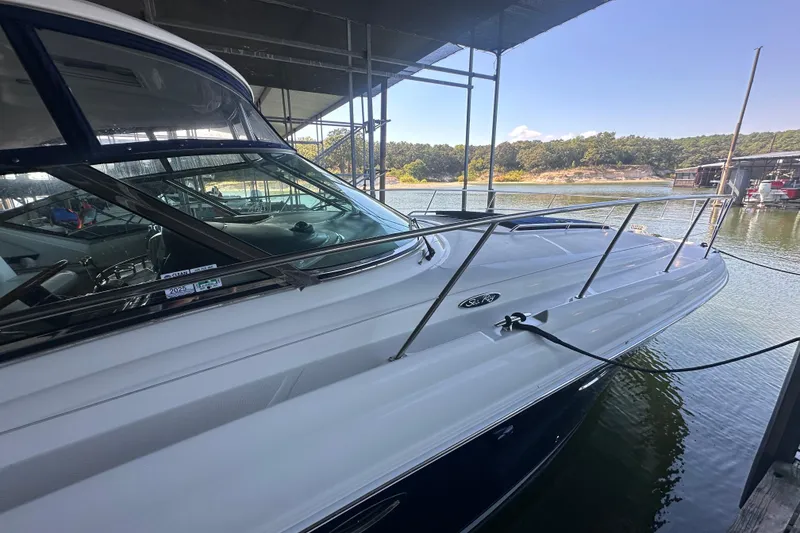 Slide: The Image of 2004 Sea Ray 420 Sundancer yacht docked at a marina under a canopy. - 36