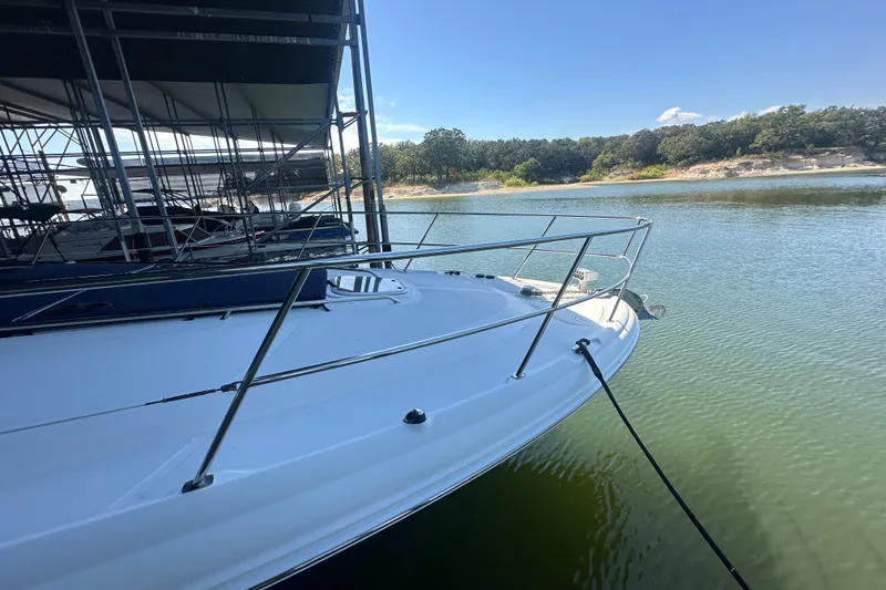 Slide: The Image of 2004 Sea Ray 420 Sundancer docked on calm water under clear blue sky. - 37