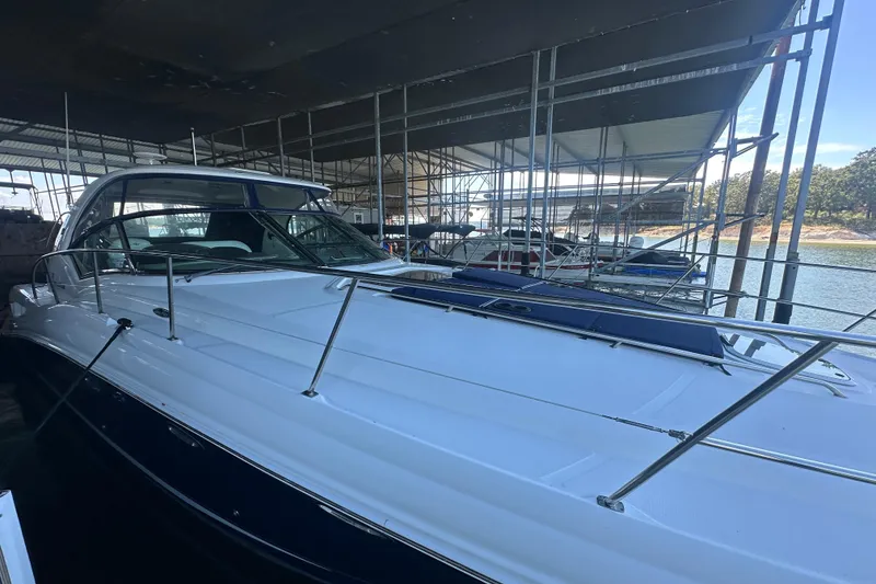 Slide: The Image of 2004 Sea Ray 420 Sundancer yacht docked under a covered marina. - 38