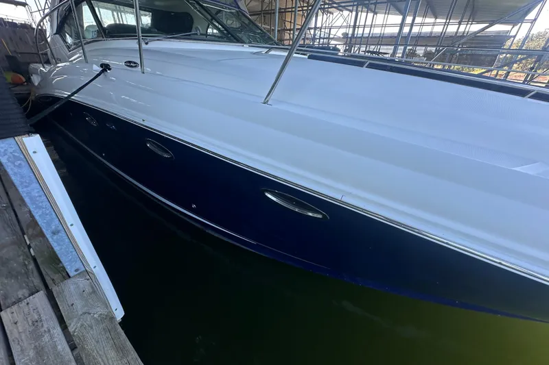 Slide: The Image of 2004 Sea Ray 420 Sundancer docked, showcasing sleek design and polished exterior. - 39