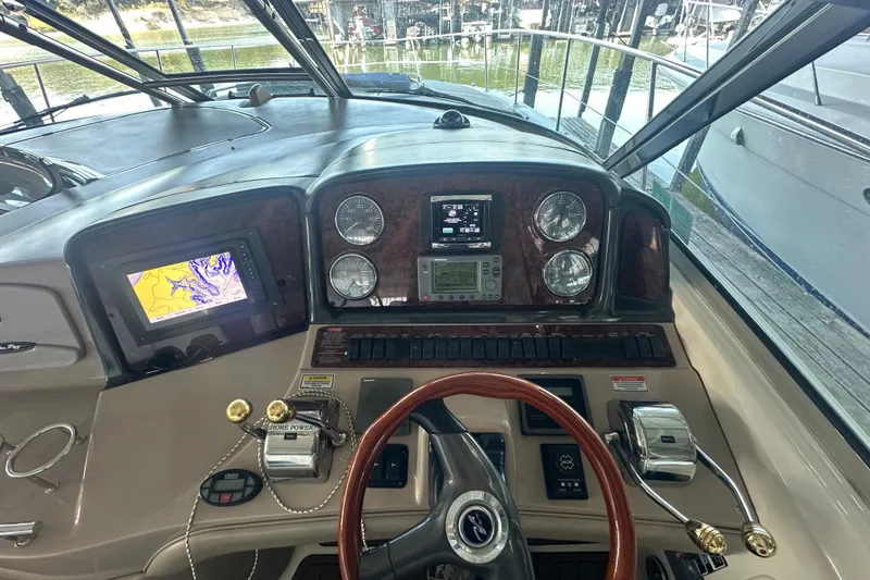 Slide: The Image of Cockpit of 2004 Sea Ray 420 Sundancer with navigation and control instruments. - 44