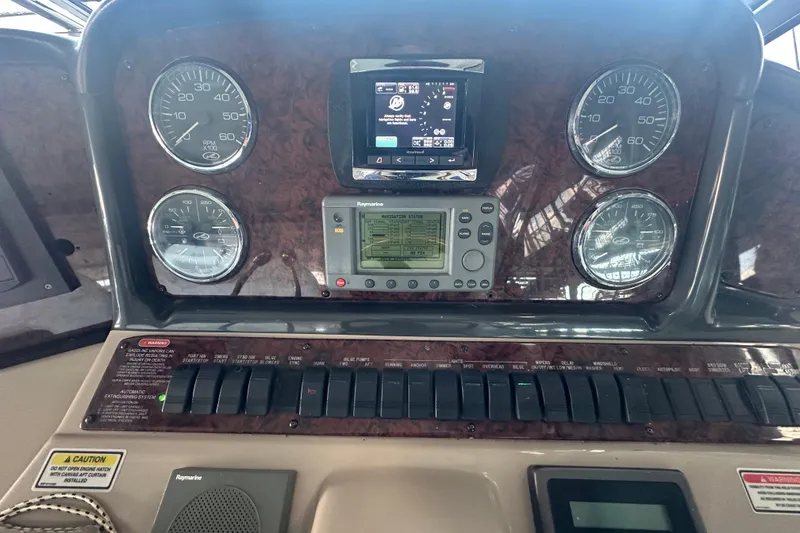 Slide: The Image of Dashboard of a 2004 Sea Ray 420 Sundancer with gauges and navigation equipment. - 46