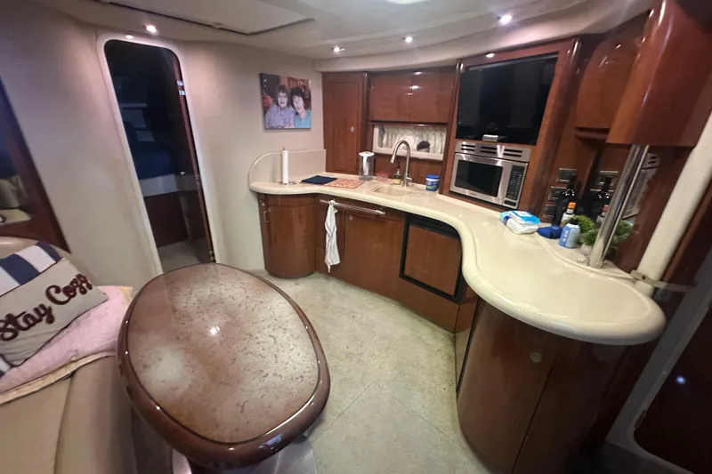 Slide: The Image of Luxurious 2004 Sea Ray 420 Sundancer yacht interior with modern kitchen amenities. - 49
