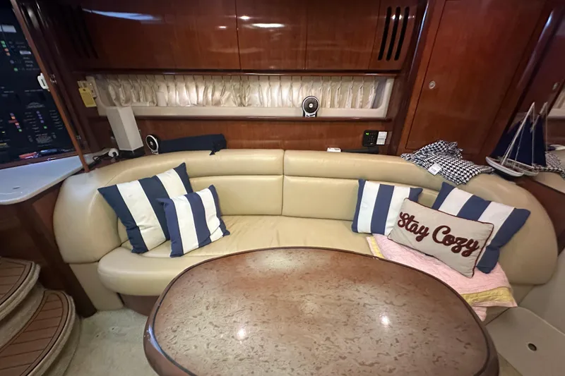 Slide: The Image of Interior of 2004 Sea Ray 420 Sundancer with cozy seating and nautical decor. - 50