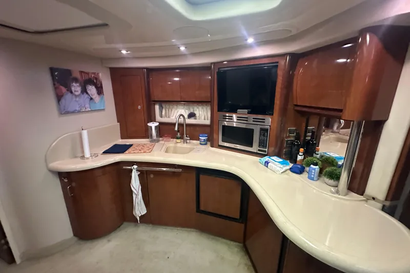 Slide: The Image of Luxurious 2004 Sea Ray 420 Sundancer yacht interior with modern kitchen amenities. - 51