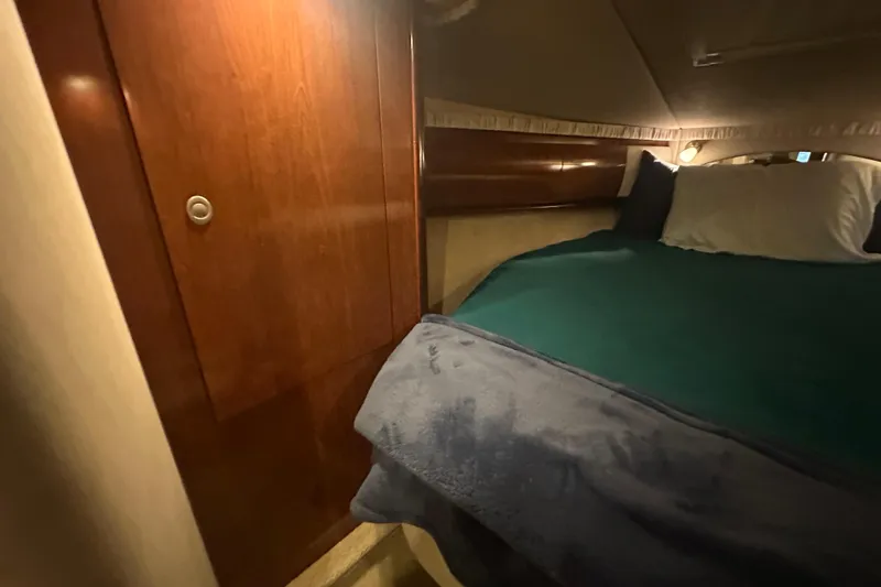 Slide: The Image of Cozy cabin interior of 2004 Sea Ray 420 Sundancer yacht with wooden paneling. - 55