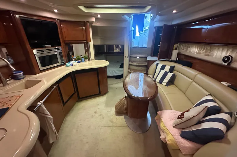 Slide: The Image of Luxurious interior of a 2004 Sea Ray 420 Sundancer yacht with elegant seating and kitchen area. - 57