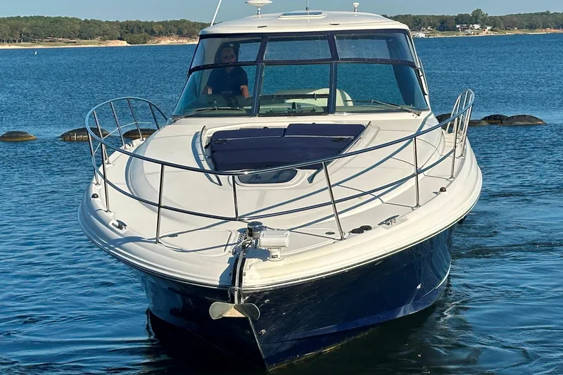 Slide: The Image of 2004 Sea Ray 420 Sundancer yacht cruising on a serene lake. - 6