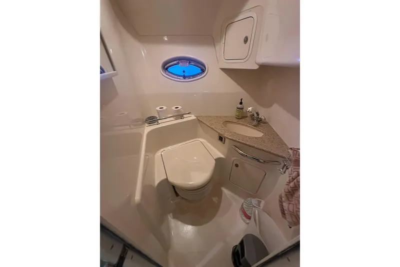 Slide: The Image of Bathroom interior of 2004 Sea Ray 420 Sundancer yacht with sink and toilet. - 62