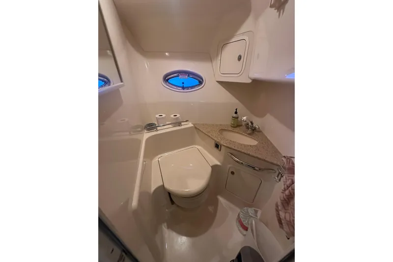 Slide: The Image of Bathroom interior of 2004 Sea Ray 420 Sundancer yacht, featuring sink and toilet. - 63