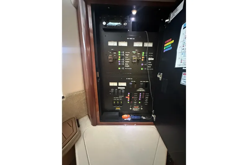 Slide: The Image of Electrical panel inside 2004 Sea Ray 420 Sundancer yacht, showcasing control switches and indicators. - 69